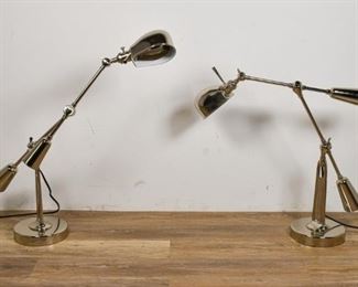 154	Pair of Ralph Lauren Chrome Lamps	Pair of Ralph Lauren lamps in the style of Edouard Wilfred Buquet. Swivel base, adjustable lamp head and spine with 3 toothed swivels. Stamped EST '67. 24" H x 24" D x 8" Diameter.
