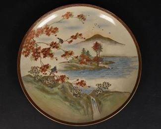 194	Japanese Satsuma Charger	Japanese Satsuma charger decorated with a landscape and Japanese maple trees. Crazing throughout. 11 3/4" Diameter.
