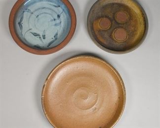 197	3 Japanese Pottery Chargers	3 Japanese pottery chargers. 1 glazed blue in the center, 1 with 3 kiln marks in the center and 1 unglazed. Largest: 15 1/2" Diameter.

