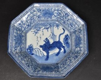 203	Japanese Blue and White Porcelain Tiger Bowl	Japanese blue and white porcelain octagonal tiger bowl circa 19/20th century. Greek key border with floral pattern on the rim. Tiger with verse in the center. 10 3 /8" L x 10 1/8" W x 3" H. Minor scratches to the center.

