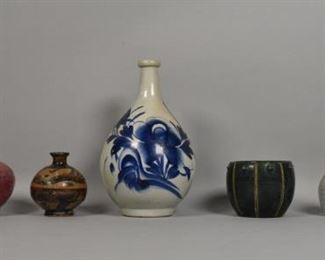207	7 Pieces of Japanese Pottery	7 Colorful Japanese pottery pieces in a variety of shapes and sizes. 4 vases, 2 bowls and 1 large vase decorated with under glaze blue flowers. Largest piece: 10" Height.
