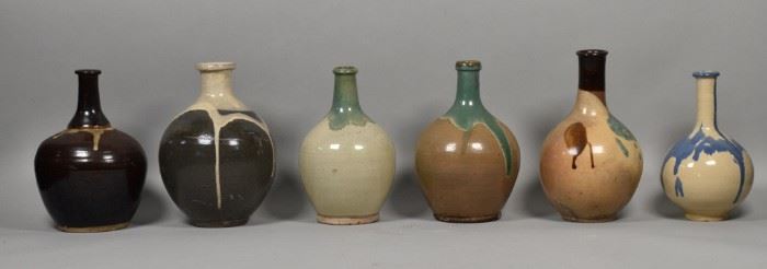 214	6 Japanese Studio Drip Glaze Vases	6 Japanese pottery vases with drip glaze, 2 Kyo Yaki ware and 2 Kasama ware. 2 brown ground with white over glaze. Tallest: 10 1/2" Height. Crazing to most vase surfaces.
