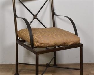 218	Diego Giacometti Style Arm Chair	Diego Giacometti (Swiss, 1902-1985) Style arm chair. Mid 20th Century. Metal chair with trestle back and cross stretcher, half moon crown, and Provincial style cushion. Wear to legs, slight rust and oxidization to seat. 41 1/2" H x 21 1/2" L x 22" W
