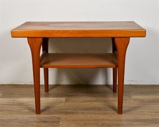 224	Danish Modern Tiered Side Table	Danish Modern tiered side table. Denmark, Mid 20th Century. Teak, four tapered feet, two tiers. Marked "MADE IN DENMARK 080678" on underside of top. Slight loss to top, some scratches. Loss to one back leg. 20" H x 29 1/2" L x 17 1/2" W
