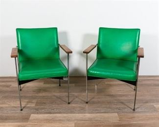 229	Pair of Mid Century Modern Green Leather Chairs	Pair of Mid Century Modern green leather chairs. American, Mid 20th Century. Green leather, metal feet and frame, wood arm rests. Labels underside chair state "SOLD BY OFFICE DESIGN, INC. 136 WILLIAM ST. NEW YORK, N.Y." Wear to seat, tears to underside of seats. 34" H x 24 1/2" L x 22" W
