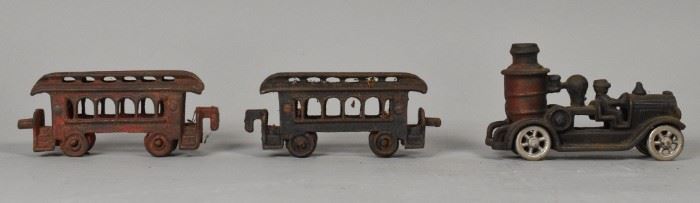 255	Cast Iron Fire Pumper and Train Cars	3 cast iron toys: a fire pumper and 2 train cars. Rust, paint loss, wear. Fire pumper: 5" L. Train car: 4 1/4" L.
