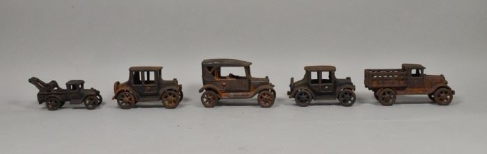 254	5 Cast Iron Vehicles	5 Cast iron vehicles; 3 cars, a truck and a tow truck. Largest vehicle: 6 1/4" L x 3 1/4" H. Loss of paint, rust present.

