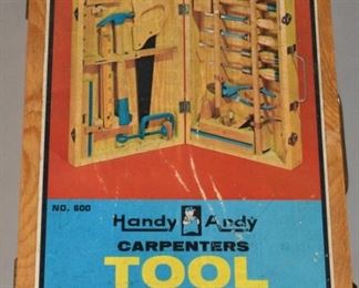 257	Handy Andy Carpenter's Tool Chest	Handy Andy carpenter's tool chest. Made in Poland, 1972. A child's carpenter set containing a hammer, chisels, and other woodworking tools. Wear to outside of box. Only piece missing from set is the saw. 3" H x 9" L x 14 1/2" D
