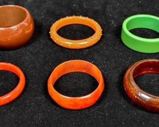 279	6 Vintage Bakelite Bangle Bracelets	Three brown, one green, one red and one studded with metal. 2 1/2" diameter opening
