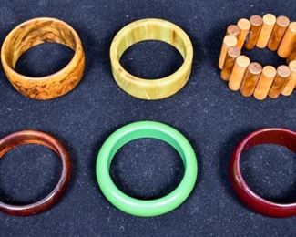 280	6 Vintage Bakelite Bracelets	One olive drab, two brown, one green, one cherry amber, one wood toned cylinders. 1 1/2" Diameter opening
