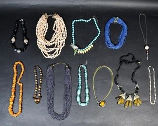 283	Grouping Of Vintage Mid Century Necklaces	12 vintage necklaces including Betsy Johnson, Coach and ATI Poland .925. Longest (multi-strand dark beads) 29 1/2"
