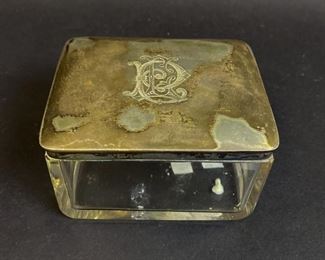 295	Crystal Box With 800 Silver Lid	Crystal box with German 800 silver lid. Lid monogrammed on outside and inscribed inside KL 15.11.1912. Hallmarked Wilhelm Binder. 2 1/4'H x 4"L x 3"W
