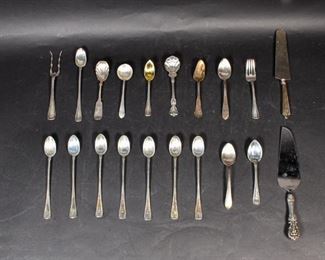 300	20 Pieces of Silver Flatware	Grouping of 20 pieces of silver flatware. Early to Mid 20th Century. 8 monogrammed iced tea spoons, 4 soup spoons, a scalloped sugar spoon, a commemorative soup spoon, a seafood fork, a salad fork, a grapefruit spoon, two cake servers with sterling handles, and a coin silver (.900) scalloped sugar spoon. Total weight of coin silver spoon is 32.61 grams, all sterling weighs in at 676.33 grams. Wear to all pieces. Pie server measures 10 1/2" L Largest object in lot: 10" L
