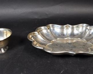 302	Sterling Silver Centerpiece Bowl and Candy Dish	Reed & Barton "Windsor" centerpiece bowl, marked on the underside " x958F". 12 1/4" L x 8 1/2" W x 1 3/4" H. Tiffany & Co. Makers candy dish. Marked on the underside " 23514 L" 4 1/4" Diameter x 2 1/2" H. Circa 1950. 571.1 grams total.
