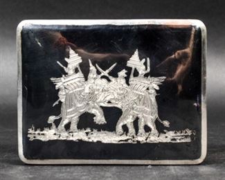 309	Bangkok Sterling & Niello Work Tobacco Box	Bangkok sterling silver and niello work tobacco box. With war elephant motif on lid. Wood lined. Stamped on the underside Bangkok Sterling. 4 1/2"L x 3 1/4"D x 1 1/4"H. Handle missing, crack to niello work on lid.

