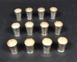 310	Set of 12 Sanborns Mexican Sterling Shot Glasses	Sanborns (Mexico, 1923-). Set of 12 sterling silver shot glasses, all with animal decoration on rims. 5 marked Sanborns Mexico Sterling, 7 marked Sanborns Mexico S. Each 1 3/4"H. 422.6 grams total.
