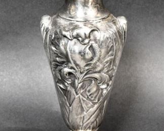 311	Unger Brothers Sterling Repousse Vase	Unger Brothers (American, Newark, NJ, 1872-1919). Sterling silver vase with repousse flower decoration. Marked with Unger Bros. UB maker's mark and 925 Fine Sterling on the underside. 7"H; 129.1 grams.
