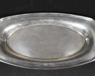 315	American Sterling Oval Dish	American sterling silver oval dish. Marked Sterling on the underside. 13"L; 406.6 grams. Scratches throughout.
