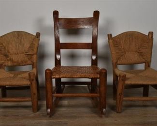 324	Three Diminutive Children's Chairs	Three diminutive children's chairs. American, Early 20th Century. A pair of wicker back and seat chairs, and a rocking chair with woven seat. Wear and scuffs to rocker, cracking to legs of wicker chairs. Largest chair measures: 24 1/2" H x 15" L x 20" W
