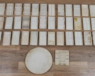 340	Large Lot of Milk Glass Trays	Approximately 40 milk glass dental trays, in various configurations. Many with chips and roughness. Most 8" x 4"W x 1"H.
