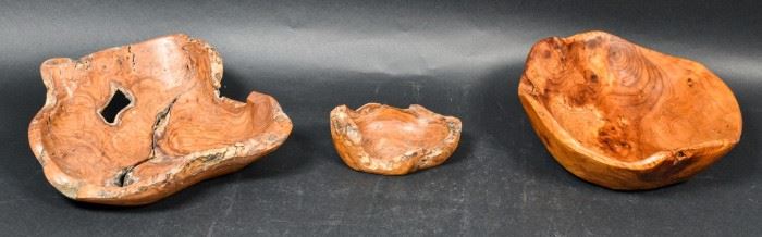 345	Grouping of Three Burled Wood Bowls	Grouping of three burled wood bowls. Mid 20th Century. Three burled wood bowls, one which is tagged on the bottom stating it was carved from an Asian fir tree stump. Some slight wear to tagged bowl. Largest bowl measures 4" H x 13" L x 12" D
