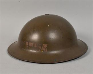 350	World War II Canadian Mark I Helmet	World War II Canadian Mark I helmet. Canadian, Early 20th Century. Manufactured by General Steel Wares. Lip of helmet marked "G.S.W. D.P. and H." Inside of helmet marked "7 1/8 VMC I 1941." Helmet still has original chin strap and lining. Scratches and wear throughout.
