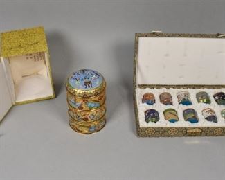353	11 Pieces of Chinese Enamel	3 tiered Chinese champleve stacking box and 10 small cloisonne boxes. Tiered boxes: 4" Diameter and 5 3/4" height. Small cloisonne box: 1 1/2" Diameter and 1 3/4" height. Padded case: 11 3/4" L x 6 1/2" W x 2 1/2" H. Each with its own box.
