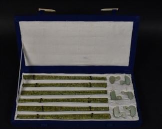 354	Chinese Carved Chopsticks and Jade Rests	Chinese carved jade chopsticks and rests. Chinese, 20th Century. A set of 6 carved chopsticks with 6 carved swan rests, in a fitted case. Slight wear to swan rests. 1 1/2" H x 12" L x 6" W
