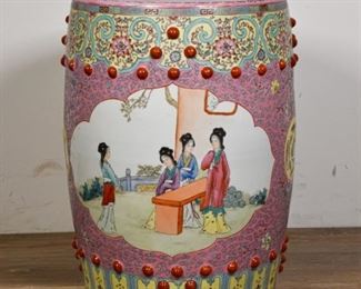 357	Chinese Famille Rose Garden Seat	Chinese famille rose garden seat. Early to Mid 20th Century. Porcelain with pink inlay, floral and Greek key motifs, with two painted scenes of ladies conversing and playing a musical instrument. Painted prunts throughout with ventilation holes. Small crack on the underside of base. 18 1/2" H x 12 1/2" diameter of top

