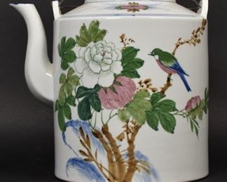 360	Chinese Teapot	Chinese teapot. Chinese, Early 20th Century. Tall porcelain teapot painted with scenes of foliage and a hummingbird. Chinese characters inscribed on top of lid. Wear to top. 10" H x 8" diameter
