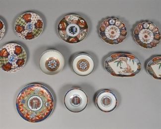 363	11 Pieces of Imari Porcelain	11 pieces of Imari porcelain. Japanese, 18th/19th century. Two lidded bowls, three bread and butter plates, a shallow dish, two flower-shaped dishes, a dessert plate painted with cranes and a heraldic center motif, and two small relish dishes with painted designs of a bird and palm tree. All gilded and painted with bright red, blue and green colors. Shallow dish, bread and butter plates and flower dishes are marked with Kanji on bottom. Wear to bottom of pieces. Dessert plate measures 1" H x 7 1/4" diameter
