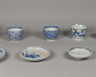 371	10 Pieces of Japanese Porcelain	10 Pieces of Japanese porcelain. 4 sakazuki or sake cups, 3 cups, 2 saucers, and 1 pottery bowl decorated with ancestors throughout. Cup: 3 1/2" Diameter. Chip to the underside of 1 cup with residue from repair. Saucer:5" Diameter. Bowl: 5 1/4" Diameter.
