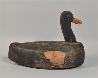 396	Black Duck Decoy	Black duck decoy. American, Early 20th Century. Carved wood with black paint, two nails on bottom as weights with remnants of leather strap. Wear throughout duck, wormholing to beak. 11" H x 7" L x 13" W
