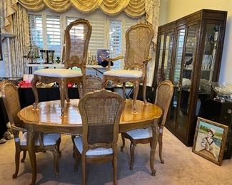 Thomasville dining table with 6 cane back chairs and 2 leaves. Excellent Condition!!