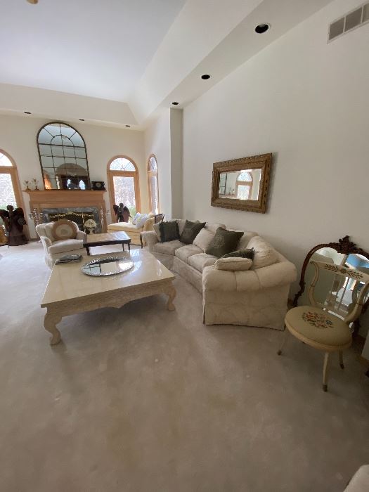 Wrap around sofa, antique mirrors, marble coffee table 