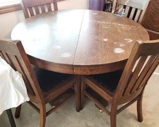 6 Leather Seat Mission Style Chairs and Round Oak Table w/two leafs