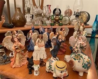 Highly detailed angel figurines, vintage piggy banks, oil lamp collection, vintage clocks