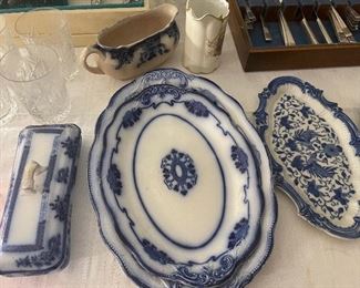 Many flow blue platters, bowls