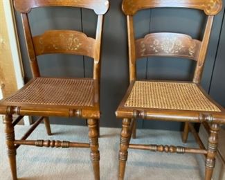 #1411L. Pair solid cherry chairs with cane seats and decal splat $145 each or $225 for the pair 