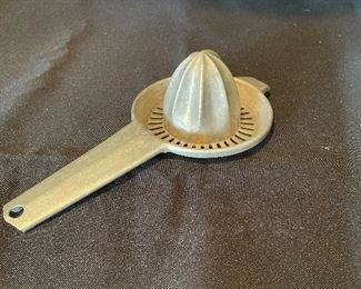 #1705A - Vintage aluminum fruit squeezer - $5