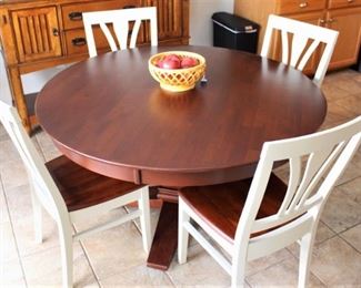 Round top dining table with four chairs.  