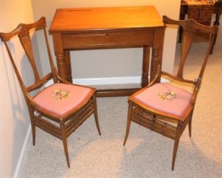 Antique oak desk, shown with two needlepoint chairs.