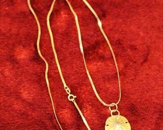 14 kt. gold chain with sand dollar pendent.                                            Finer jewelry is never left on premises overnight.