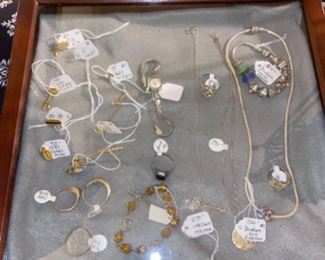 Gold and silver jewelry, including men’s rings.