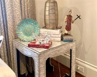 Upholstered end table and antique St. Peter polychrome Santo