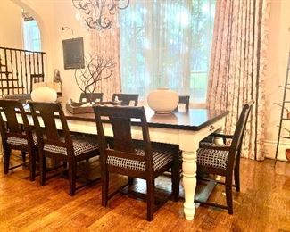 Farm style dining table with multiple leaves and 8 chairs.