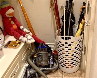 Dyson canister vacuum and two Electrolux cordless vacuums.