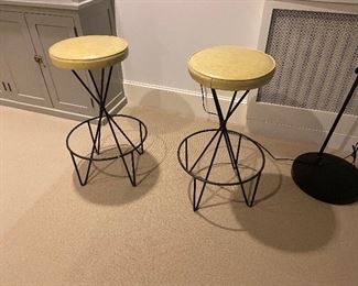 Two of four matching midcentury metal bar stools.  18" diameter at the base, 14" diameter at the top by 30 1.2"h. Frederick Weinberg.  $1400 per pair.  One pair needs repair of stitching on one stool.  That pair is $1200.