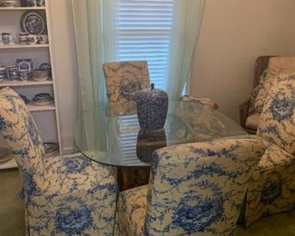 Glass top table with four yellow and blue Toile upholstered chairs