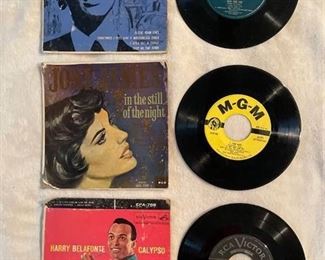 Three classic 45 rpm records with sleeves